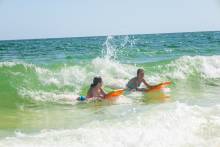 Kids boogie boarding in the Gulf