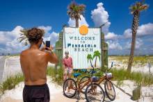 Taking photos at iconic Pensacola Beach Sign