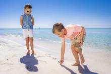 Kids searching for seashells on Pensacola Beach