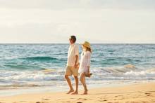 Couple walking along Navarre Beach, Florida