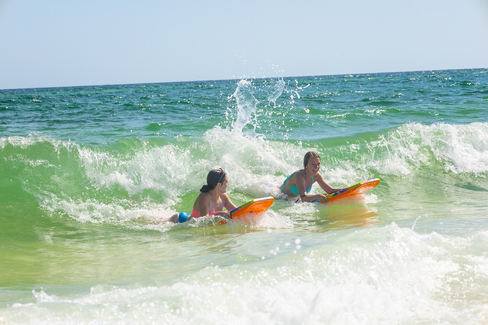 Kids boogie boarding in the Gulf Kids boogie boarding in the Gulf