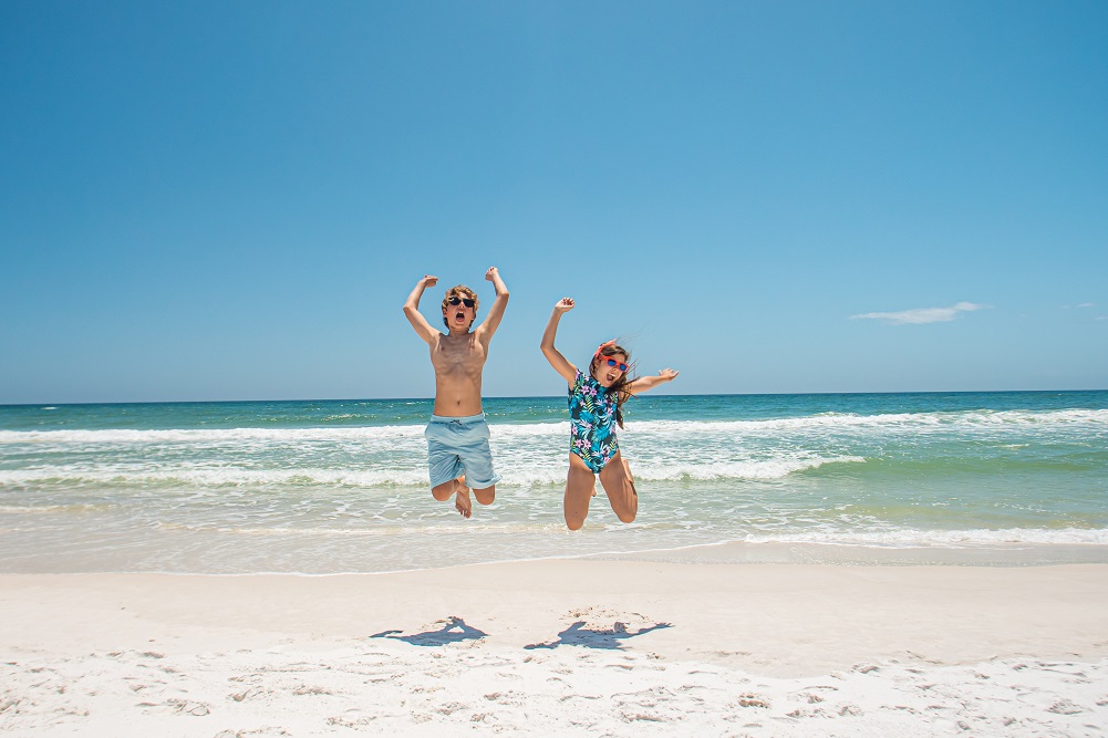 Kids jumping in excitment for Spring Break on Pensacola Beach